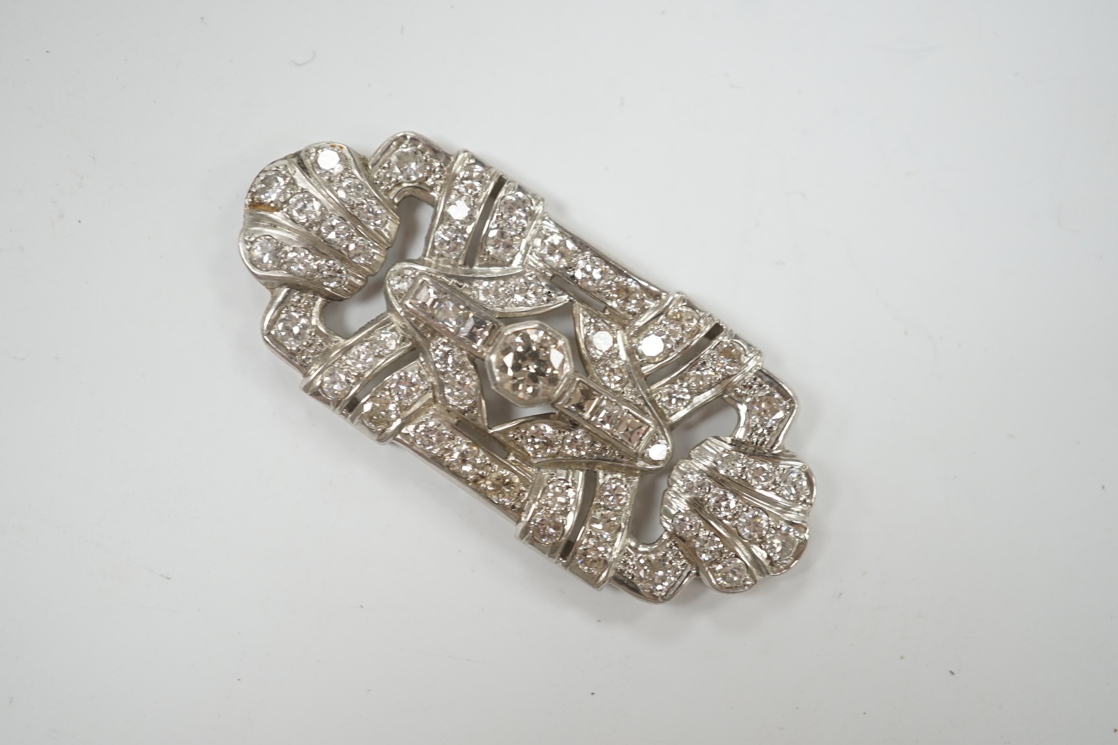 A white metal and diamond cluster set shaped rectangular brooch? (lacking fittings)